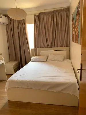 a bedroom with a white bed with a window at Cosy & chill home in Marrakech