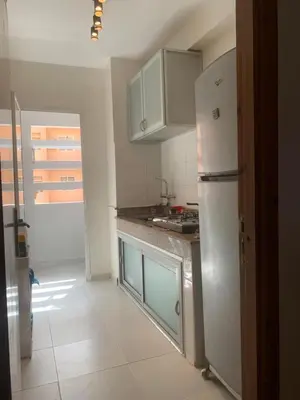 a kitchen with a refrigerator and a counter top at Cosy & chill home in Marrakech