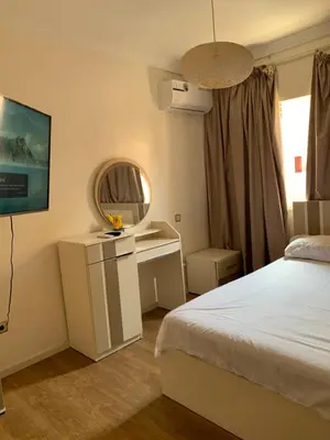 a hotel room with a bed and a mirror at Cosy & chill home in Marrakech
