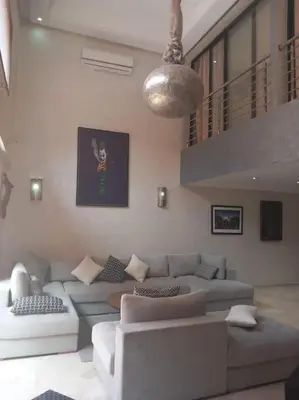 a living room with a couches and a ceiling at Appartement Duplex Haut Standing in Marrakech