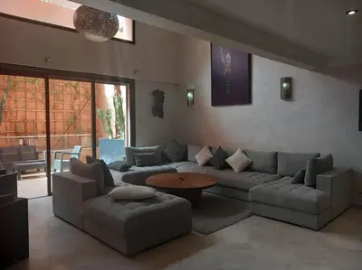 a living room with a couch and a table at Appartement Duplex Haut Standing in Marrakech