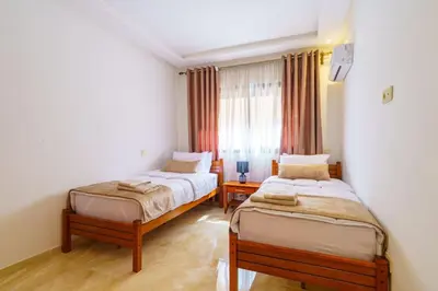 a bedroom with two beds and a window at Luxury Appartement Cosy 2BR City center Secure Parking Wifi in Marrakech