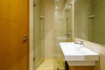 a bathroom with a sink and a glass shower at Luxury Appartement Cosy 2BR City center Secure Parking Wifi in Marrakech