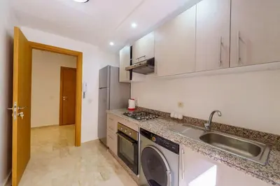 a kitchen with a sink and a washing machine at Luxury Appartement Cosy 2BR City center Secure Parking Wifi in Marrakech