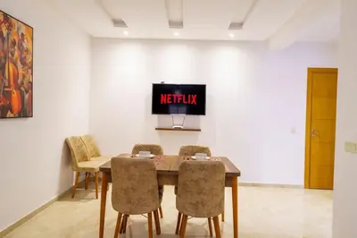 a dining room with a table and chairs at Luxury Appartement Cosy 2BR City center Secure Parking Wifi in Marrakech