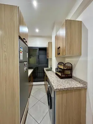 a kitchen with a refrigerator and a dishwasher at Stylisches City-Apartment im Herzen von Marrakech Gueliz in Marrakech
