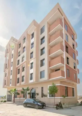 a building with a car parked in front of it at Stylisches City-Apartment im Herzen von Marrakech Gueliz in Marrakech