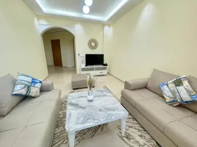 a living room with a couch and a table at Residence Blida Gueliz 2 Chambres in Marrakech