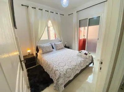 a bedroom with a bed and a window at Appart élégance Gueliz in Marrakech