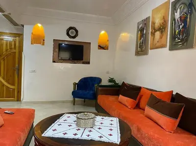 a living room with a couch and a tv at Appart élégance Gueliz in Marrakech
