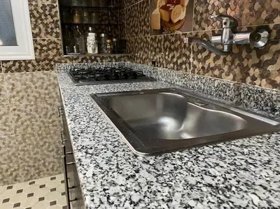a kitchen with a stainless steel sink and a stove at Appart élégance Gueliz in Marrakech