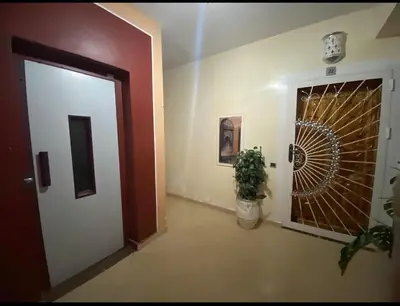 a hallway with a door and a plant next to it at Appart élégance Gueliz in Marrakech