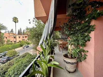 a balcony with potted plants on the side of a building at Appartement luxe type Suite hôtel Hivernage in Marrakech