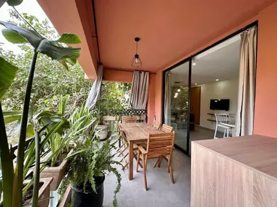 a dining room with a table and some plants at Appartement luxe type Suite hôtel Hivernage in Marrakech