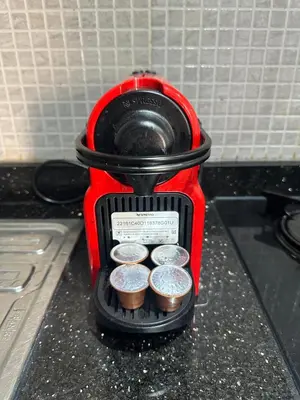 a coffee maker on a counter with coins in it at Studio T2 vu sur piscine in Marrakech
