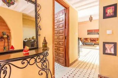 a room with a mirror and a table with a mirror at Al Qaria Assiyahia Riad Fadil 44 in Marrakech