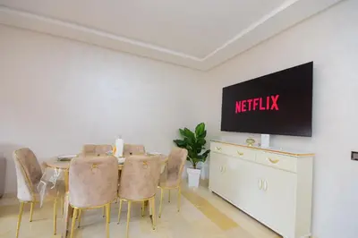 a meeting room with a table and chairs and a television at Cosy flat - gueliz residency in Marrakech