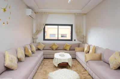 a living room with a couch and a table at Cosy flat - gueliz residency in Marrakech