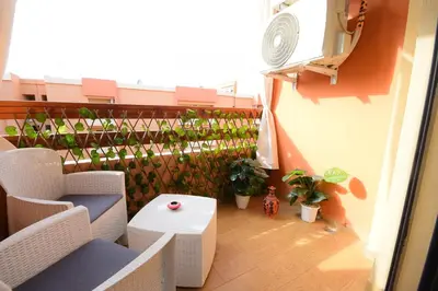 a balcony with plants and a table on a building at Cosy flat - gueliz residency in Marrakech