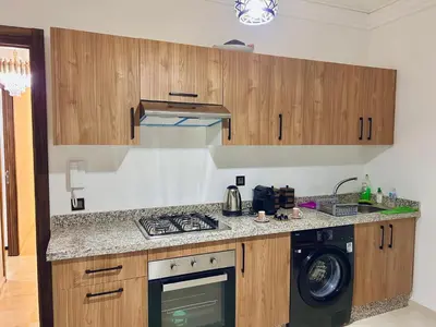 a kitchen with a stove and a washing machine at Cosy flat - gueliz residency in Marrakech