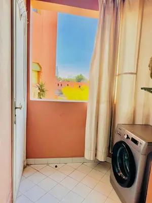 a washing machine in a room with a window at bel appartement résidence atlas hivernage in Marrakech