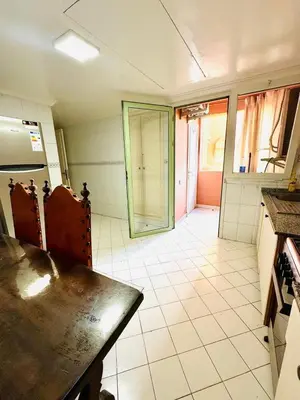 an empty kitchen with a table and a glass door at bel appartement résidence atlas hivernage in Marrakech