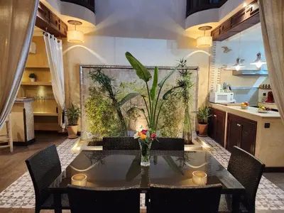 a dining room with a table and some plants at Riad Mumtaz Marrakech in Marrakech