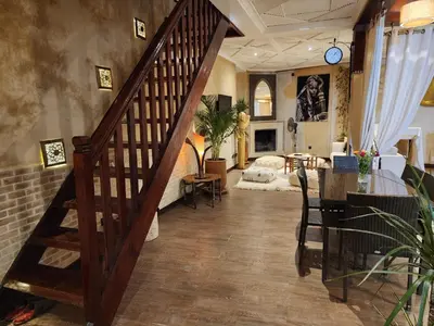a living room with a staircase and a room with a couch at Riad Mumtaz Marrakech in Marrakech