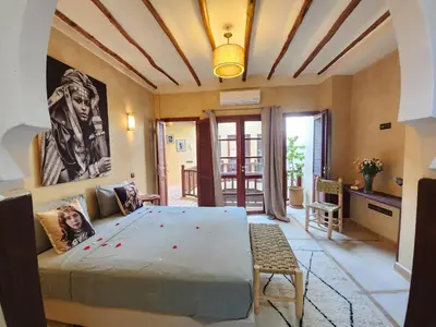 a bedroom with a large bed in a room at Riad Mumtaz Marrakech in Marrakech