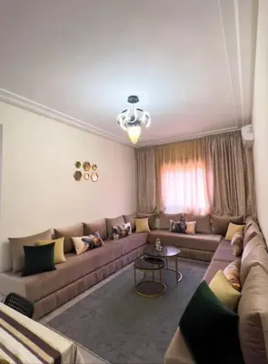 a living room with a couch and a table at Proche Gueliz T3 Piscine Parking Wifi in Marrakech