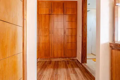 a closet with a wooden door in a room at Duplex romantique Esprit palais à Gueliz in Marrakech