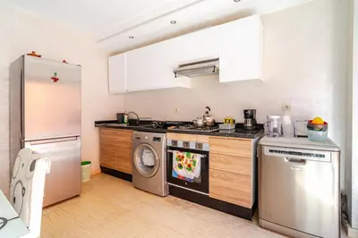 a kitchen with a refrigerator and a washer and dryer at Duplex romantique Esprit palais à Gueliz in Marrakech