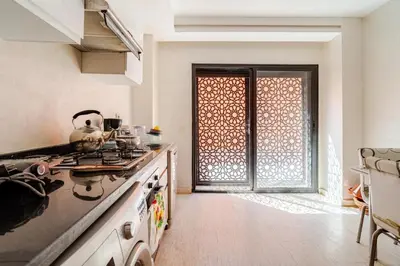 a kitchen with a stove top oven next to a door at Duplex romantique Esprit palais à Gueliz in Marrakech