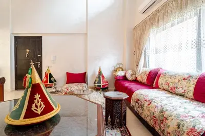 a living room with a red couch and christmas trees at Duplex romantique Esprit palais à Gueliz in Marrakech