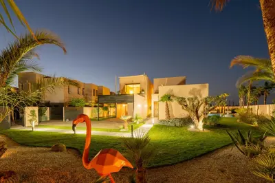 a flamingo is standing in front of a house at Villa Piscine, Salle de Sport et Confort Moderne in Marrakech