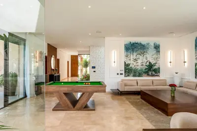 a living room with a pool table at Villa Piscine, Salle de Sport et Confort Moderne in Marrakech