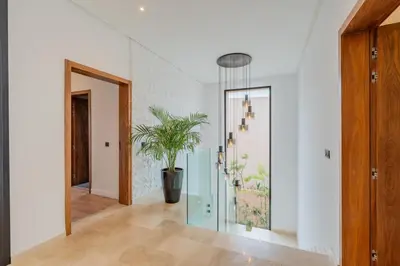 a hallway with a potted plant on the wall at Villa Piscine, Salle de Sport et Confort Moderne in Marrakech