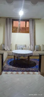 a living room with a table and a couch at Nassim 298 in Marrakech