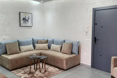 a living room with a couch and a table at Luxury Condo in Downtown Hivernage Neighborhood in Marrakech