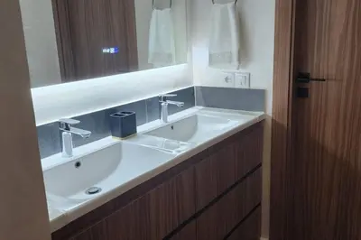a bathroom with a white sink and a mirror at Luxury Condo in Downtown Hivernage Neighborhood in Marrakech