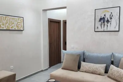 a living room with a couch and a picture on the wall at Luxury Condo in Downtown Hivernage Neighborhood in Marrakech