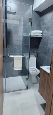 a bathroom with a toilet and a glass shower at Luxury Condo in Downtown Hivernage Neighborhood in Marrakech