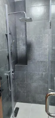 a shower with a glass door in a bathroom at Luxury Condo in Downtown Hivernage Neighborhood in Marrakech