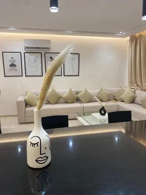 a white vase sitting on a table in a living room at Haut standing coeur Gueliz in Marrakech
