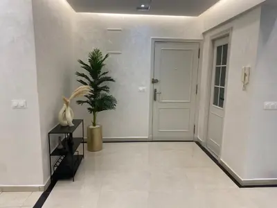 a hallway with a door and a potted plant at Haut standing coeur Gueliz in Marrakech