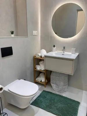 a bathroom with a sink and a toilet and a mirror at Haut standing coeur Gueliz in Marrakech