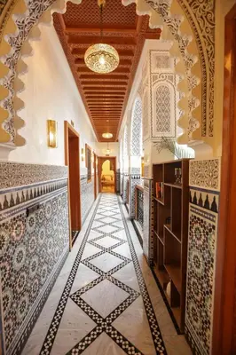 a hallway of a building with tiles on the floor at Riad Palais MERYEM in Marrakech