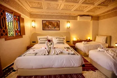 a bedroom with two beds with swans on them at Riad Palais MERYEM in Marrakech