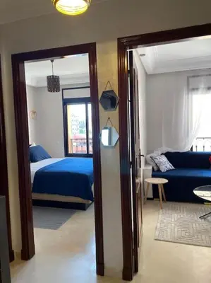 a bedroom with a blue bed and a blue couch at Stylish & Comfy Gem 5 Star Location Balcony in Marrakech