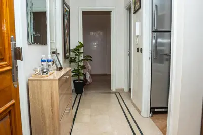 a hallway with a kitchen with a refrigerator at Boho Haven Hivernage - Plein centre ville in Marrakech